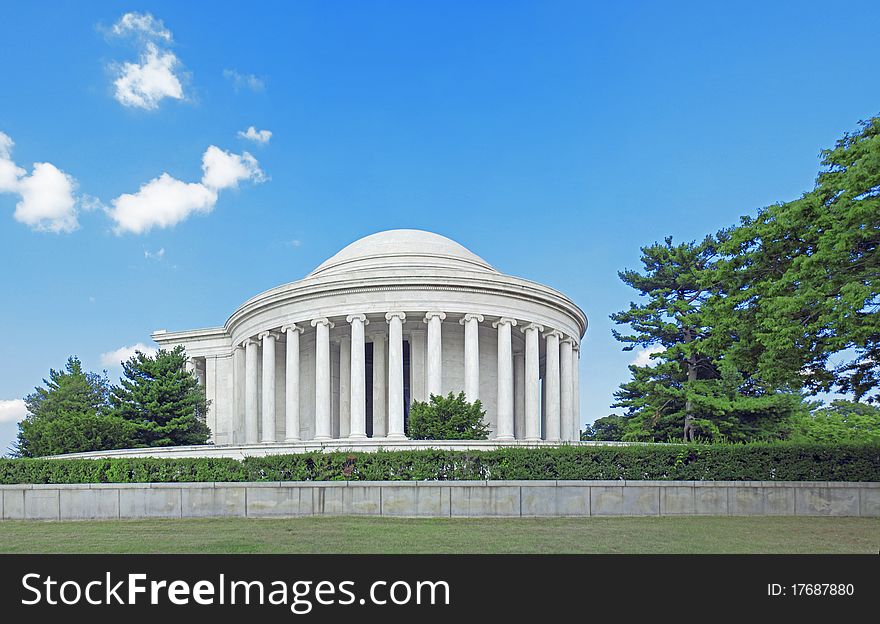 A panorama photo of the Jefferson Memorial from the side of the Tidal Basin water reservoir.