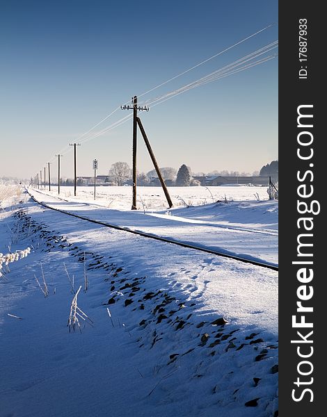 Railway track in winter with snow and hoarfrost