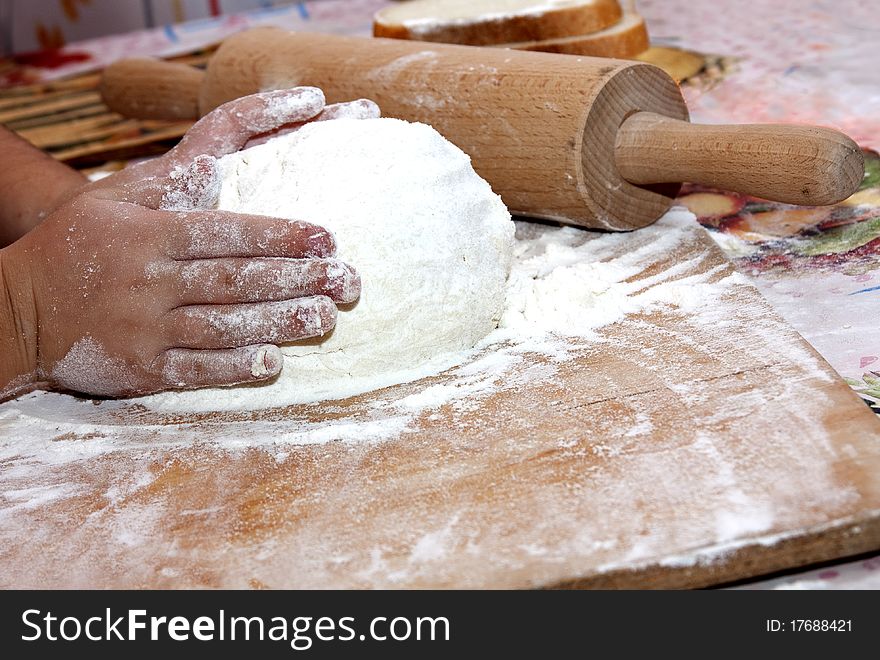 Knead the dough on the floured table. Knead the dough on the floured table