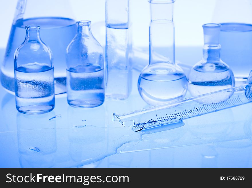 Laboratory glass. Glassware on the blue background.