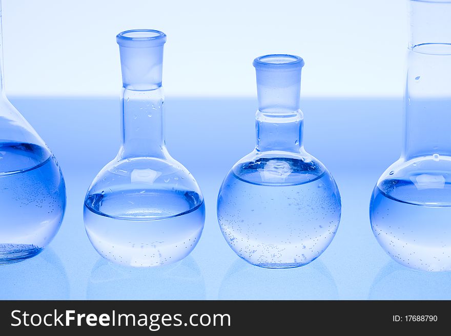 Laboratory glass. Glassware on the blue background.