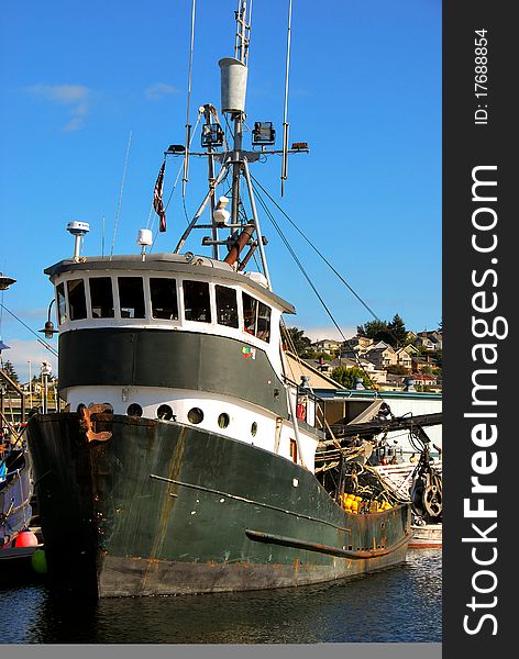 Commercial fishing boat docked in harbor.