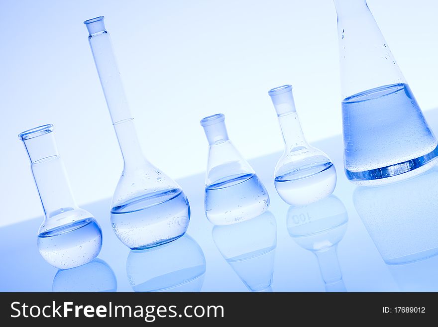 Laboratory glass. Glassware on the blue background.