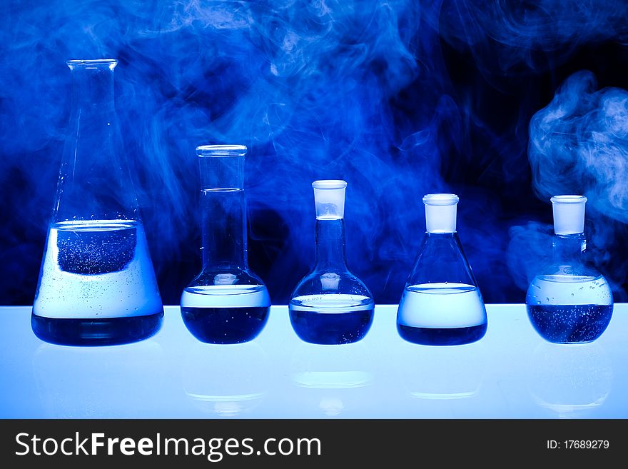 Laboratory glass. Glassware on the blue background.