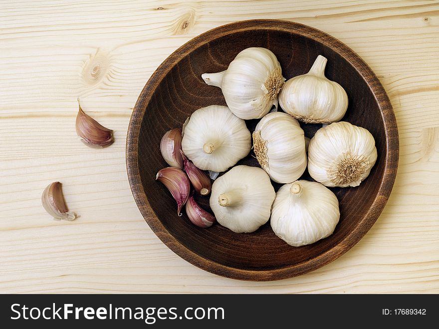 Garlic bulbs on a wooden board