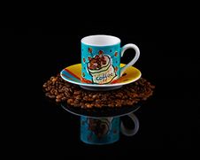 Colourful Coffee Cup And Saucer On Roasted Beans Royalty Free Stock Photography Colourful Coffee Cup And Saucer On Roasted Beans Royalty Free Stock Photography