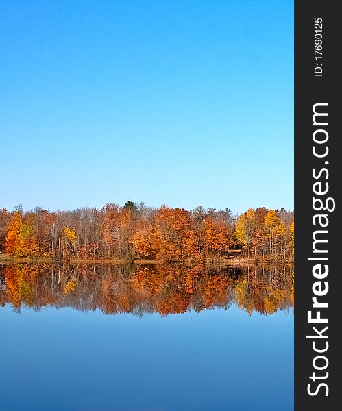 Fall trees reflecting mirror image on lake at Council Grounds State Park, WI. Fall trees reflecting mirror image on lake at Council Grounds State Park, WI