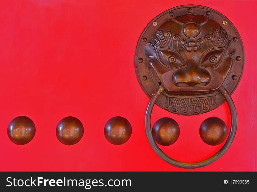Chinese lion head door knocker on red door