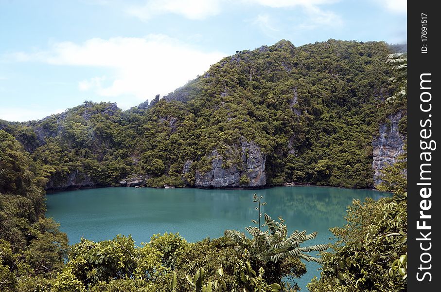 Hidden lake in the jungle surrounded by cliffs and trees,image was taken in Thailand