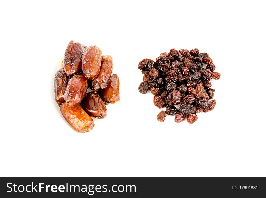 Pile of raisins beside pile of dates. Pile of raisins beside pile of dates