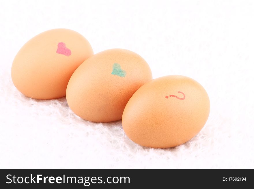 Three eggs lying down on a white background