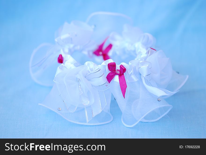 A delicate wedding garter waiting to be put on. A delicate wedding garter waiting to be put on