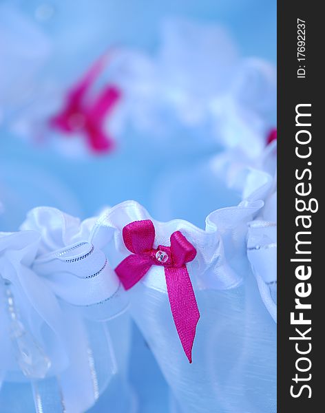 Detail of a delictae wedding garter during bridal preparation. Detail of a delictae wedding garter during bridal preparation