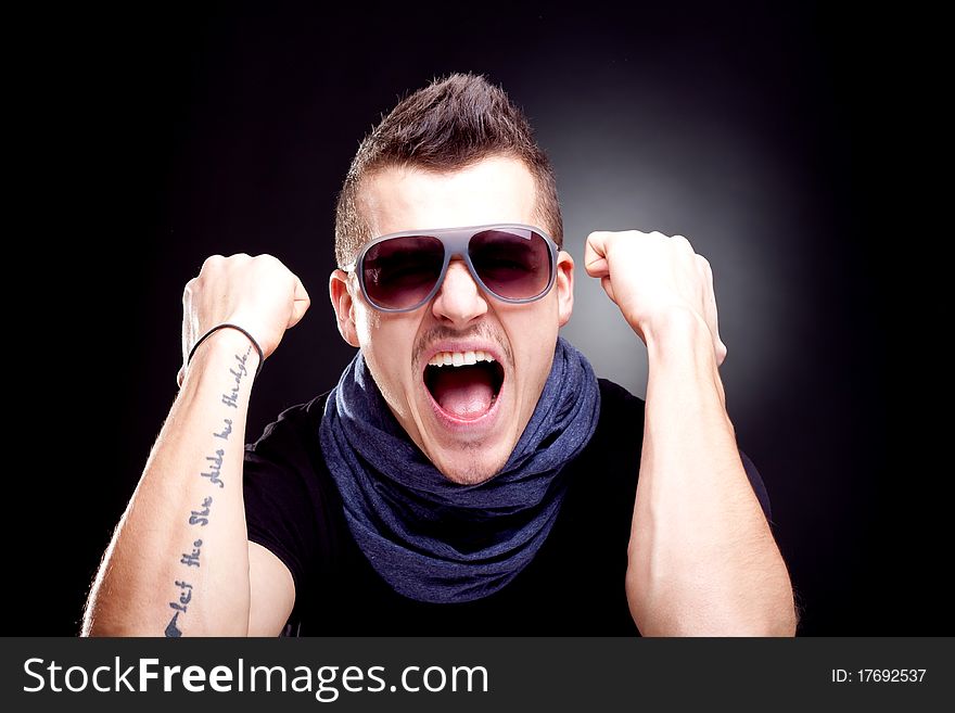 Man screaming with fists in the air - studio shot