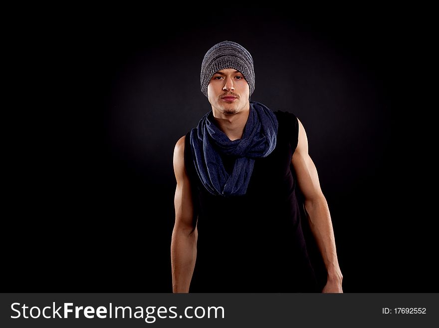 Young man with perfect body and attractive face wearing modern clothes and scarf posing. Young man with perfect body and attractive face wearing modern clothes and scarf posing