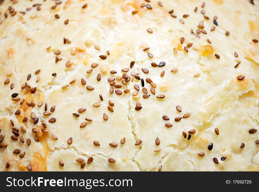 The top of a homemade cake with tan sesame seeds. The top of a homemade cake with tan sesame seeds