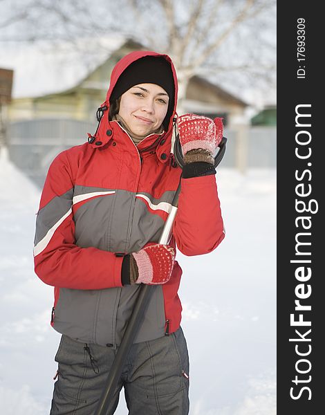 The girl in a red jacket and mittens in snow winter