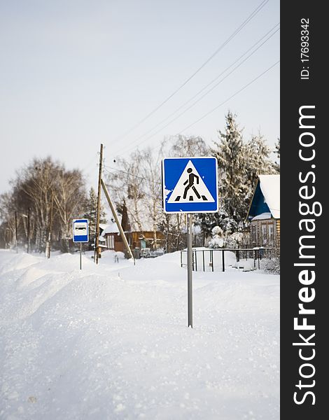 Pedestrian crossing traffic sign on winter road