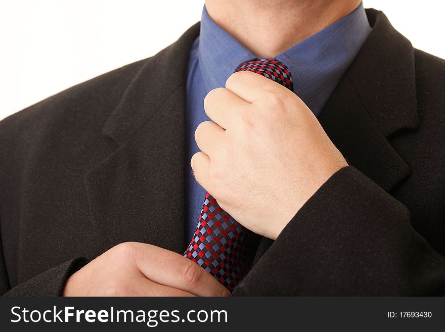 Businessman adjusting his tie