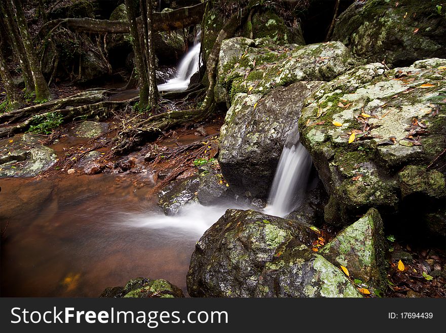 Cascades in australian rain forest with rocks