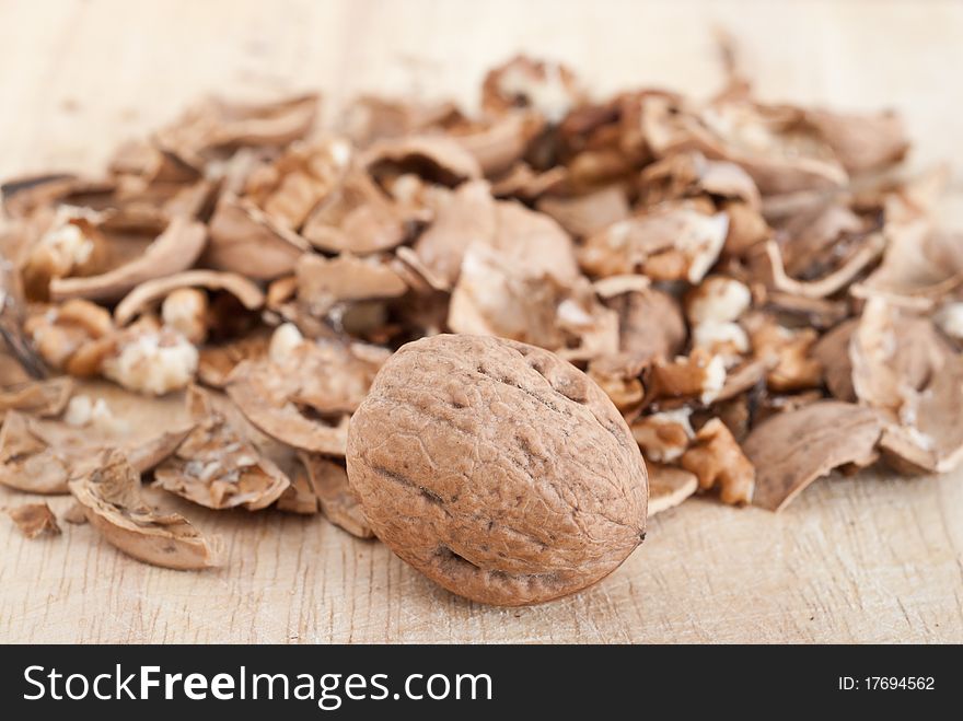 Cracked walnuts on wooden board