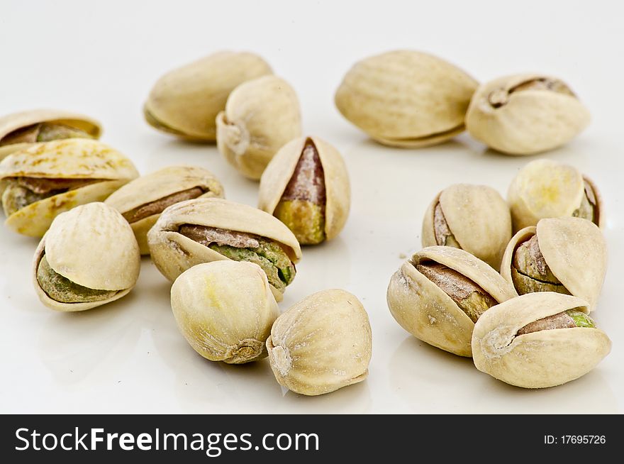 Salted pistachios isolated on white background