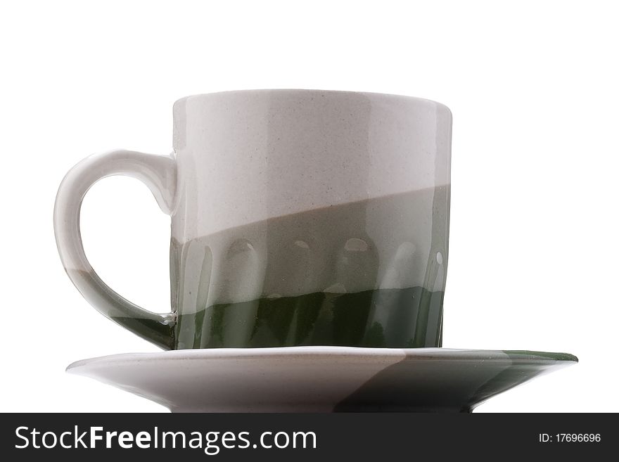 Ceramic mug and saucer with greyish green for hot drinks.