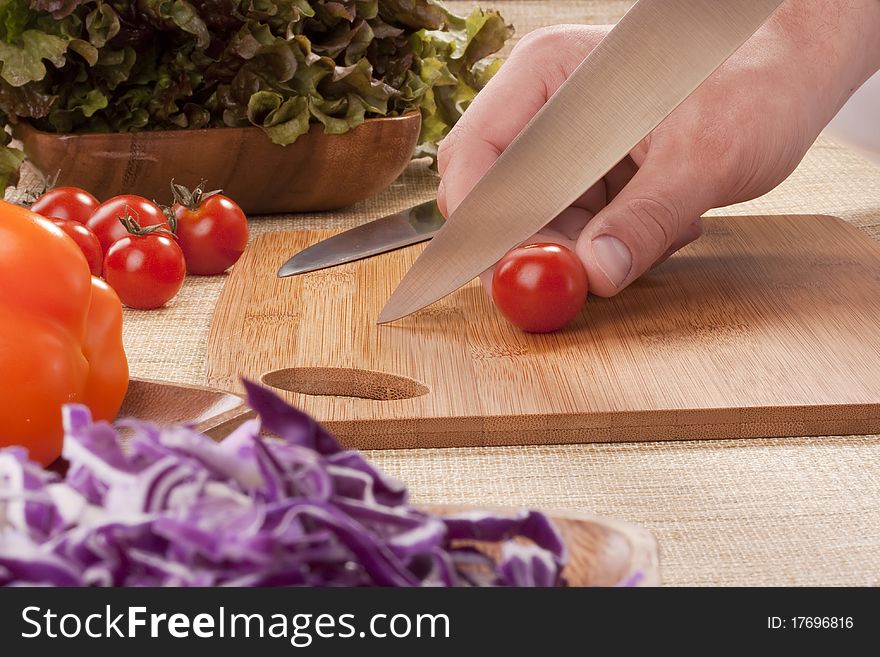 Chef Man cut vegetables on kitchen blackboard.