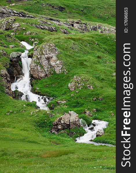 Waterfall in green alps mountains, near Grindelwald. Waterfall in green alps mountains, near Grindelwald