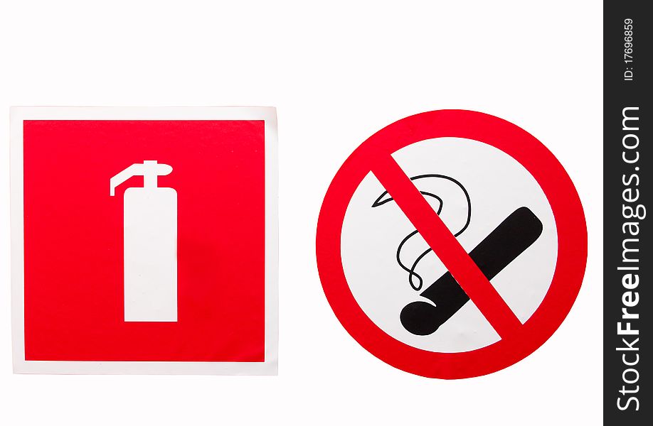 No smoking sign and a fire extinguisher on the wall. No smoking sign and a fire extinguisher on the wall