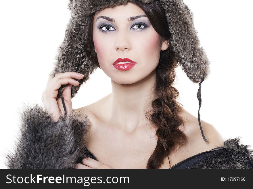 Portrait of young beautiful woman in a fur coat and hat