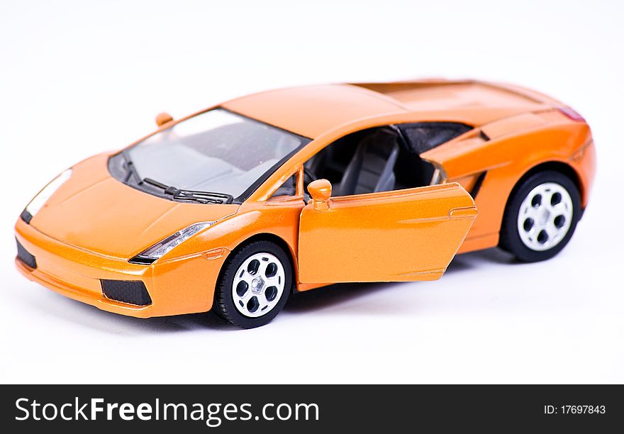 Orange metal sport car model with doors open.