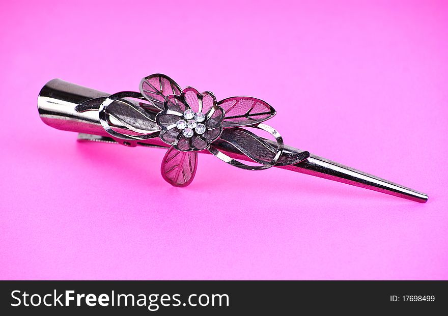 Hair-pin on the pink isolated background