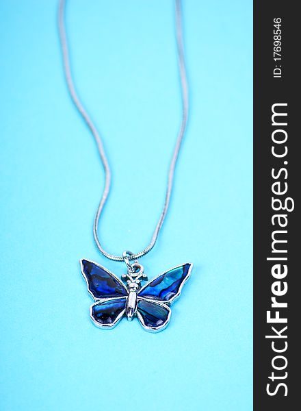 Chainlet with butterfly on blue background