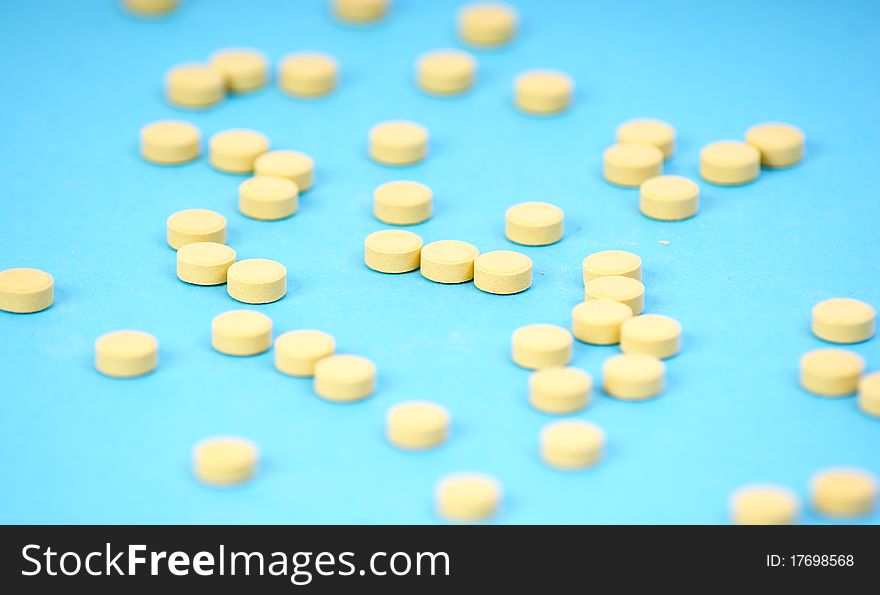 Yelloy tablets on blue background