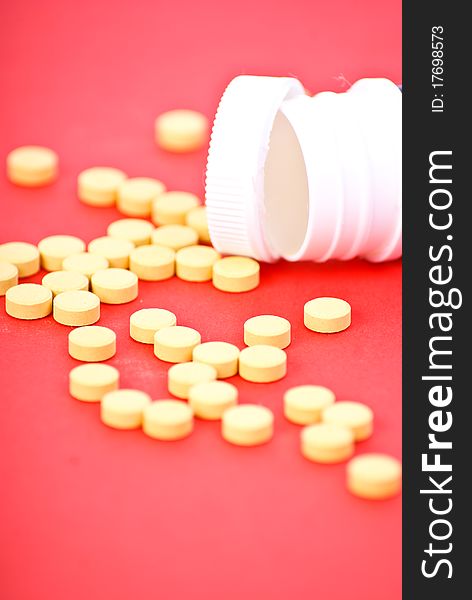 Yelloy tablets on red background