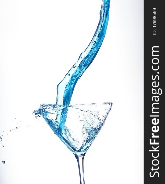 Splashing blue cocktail on the white background