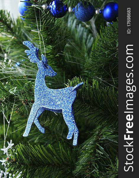 blue raindeer ornament hanging from tree