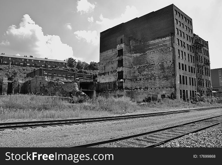Dilapidated factory near the railroad tracks. Dilapidated factory near the railroad tracks