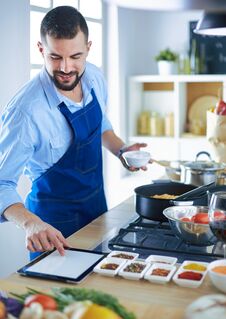 Man Preparing Delicious And Healthy Food In The Home Kitchen Stock Images