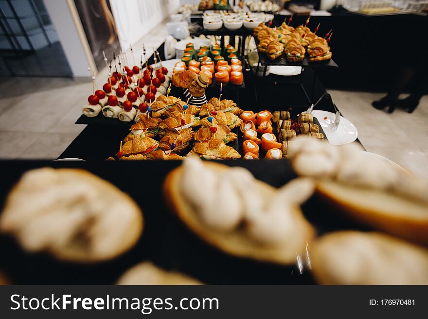 Beautifully Decorated Catering Banquet Table With Different Food Snacks And Appetizers With Sandwich