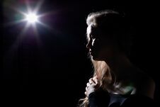 Portrait Of A Girl Illuminated By The Contour Light Of A Flash On A Black Background Royalty Free Stock Image