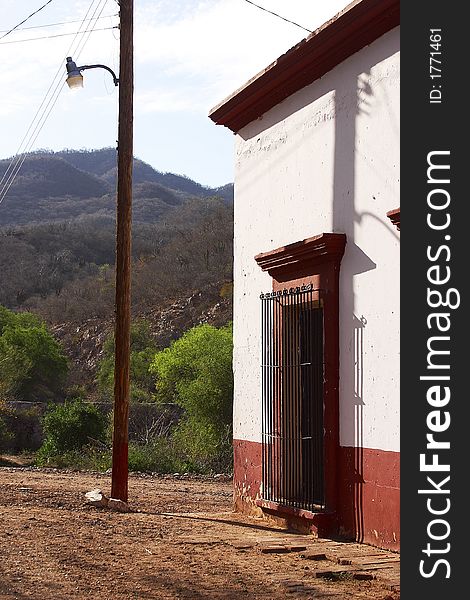 Typical colonial house with window in the town of Alamos, in the northern state of Sonora, Mexico, Latin America