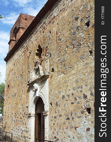 Stoned wall with tower of a chapel in the town of Alamos, in the northern state of Sonora, Mexico, Latin America