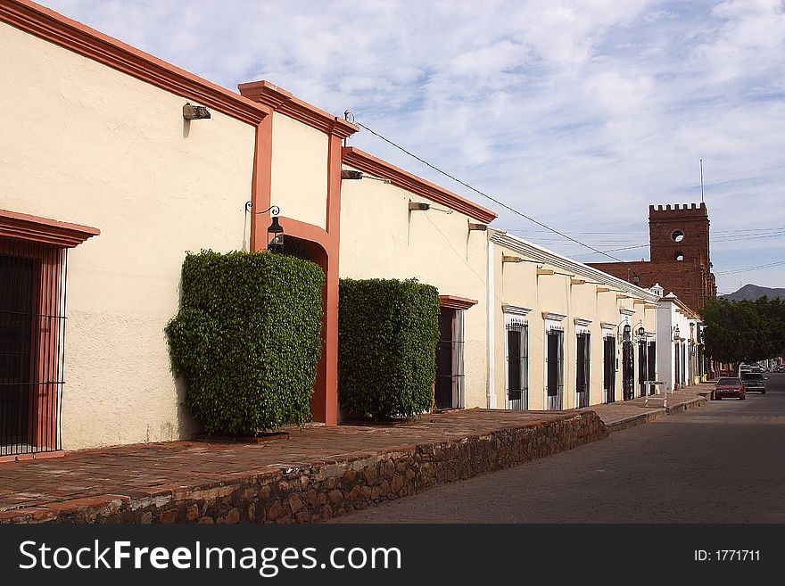 General view of a street, sidewalk and colonial houses in the centre of the town of Alamos in the northern state of Sonora, Mexico, Latin America