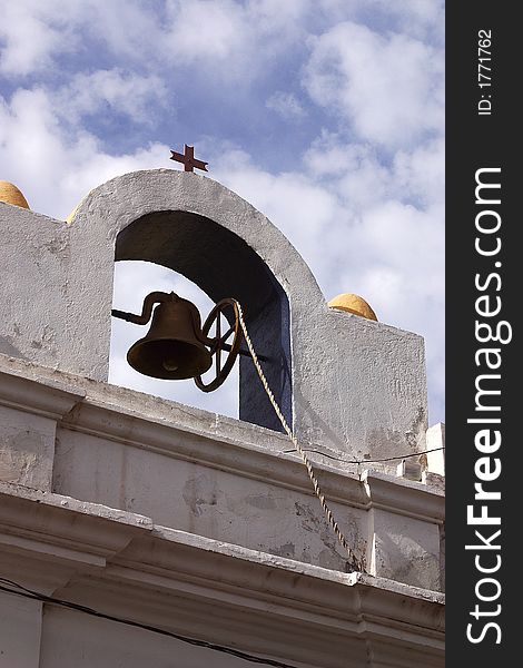 Detail of the top of a house with its bell and the sky behind in the town of Alamos in the northern state of Sonora, Mexico, Latin America