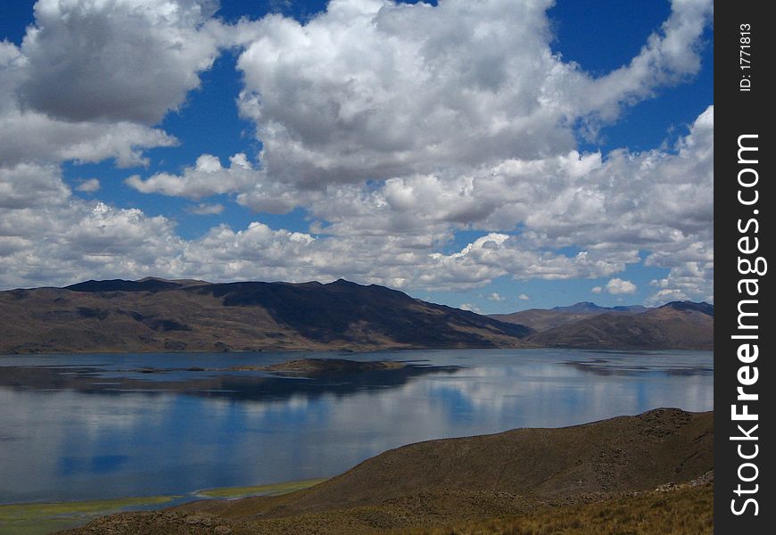 Blue Puffy Clouds  reflected in lake. Blue Puffy Clouds  reflected in lake