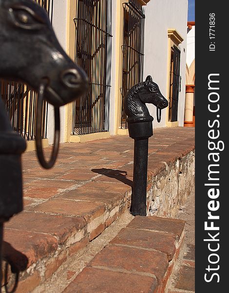 Detail of the entrance to a colonial house with 2 bronce hourses in the town of Alamos in the northern state of Sonora, Mexico, Latin America