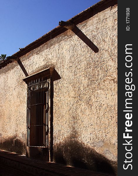 Typical colonial wall with window in the town of Alamos in the northern state of Sonora in Mexico, Latin America