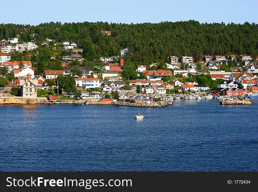 A village harbour on a fjord approaching Oslo, Norway. A village harbour on a fjord approaching Oslo, Norway